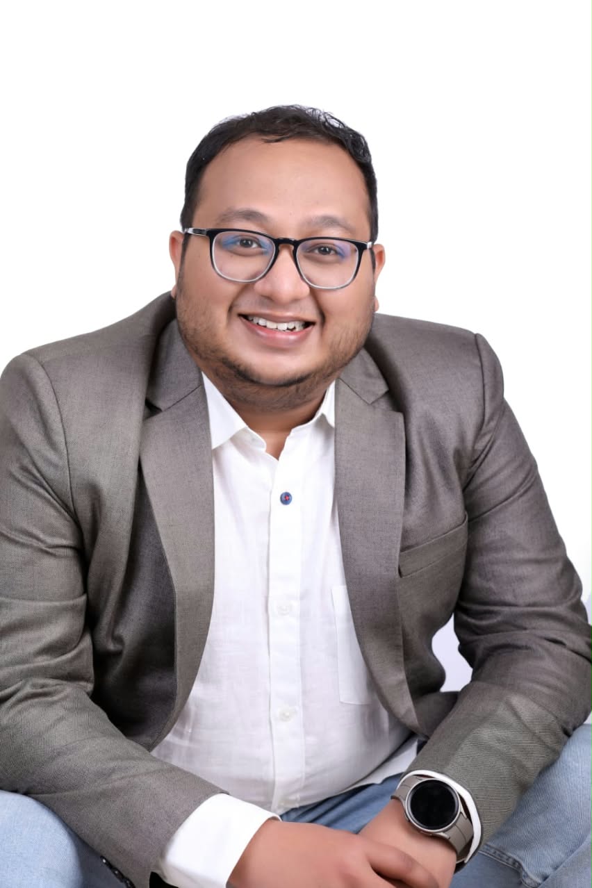 Athul Pradeep seated in a professional portrait